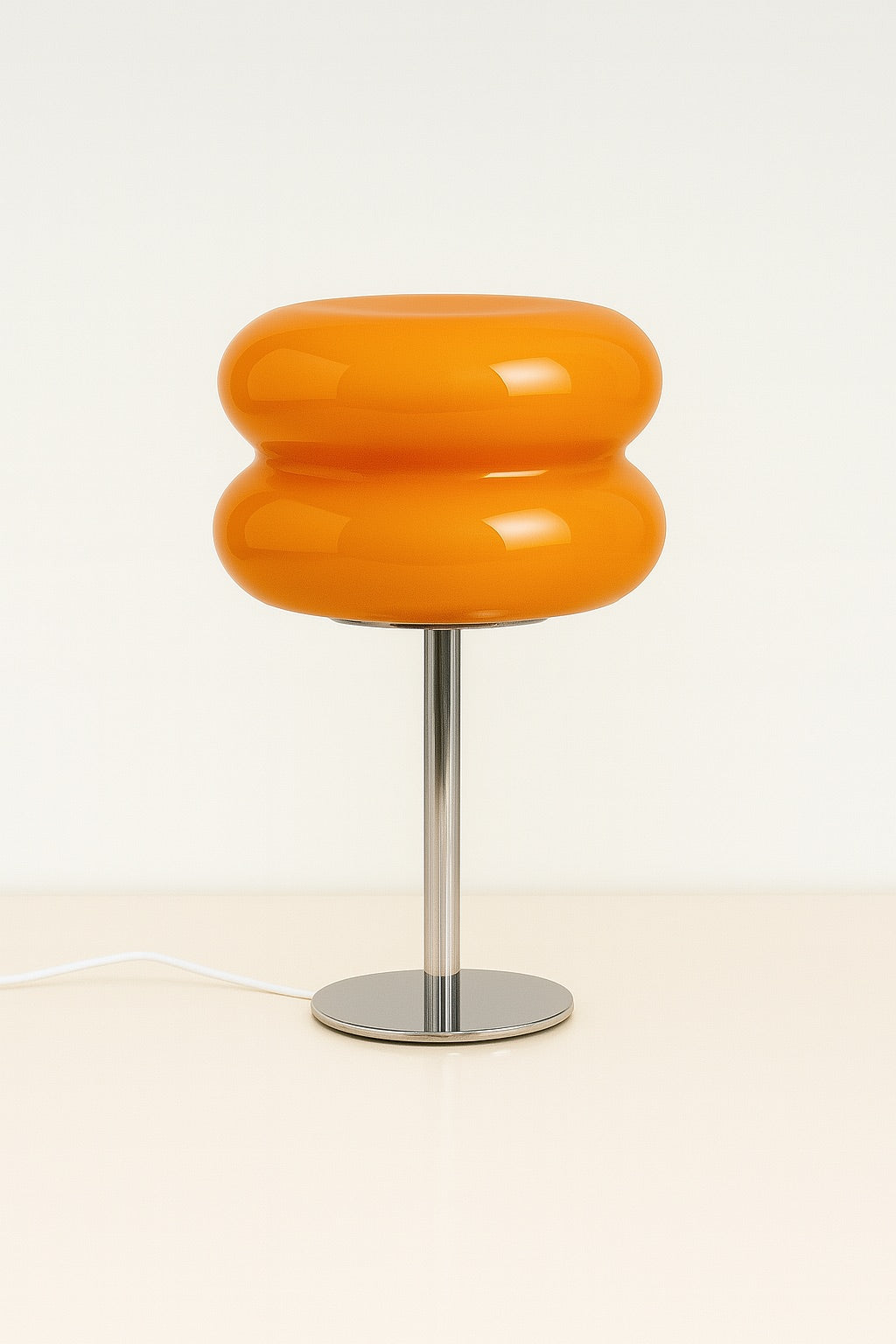 Vibrant tangerine orange GlowPop lamp with curved silhouette and warm LED dimmable glow